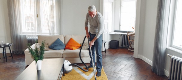 tall-man-vacuuming-floor-at-apartment-3867613.jpg